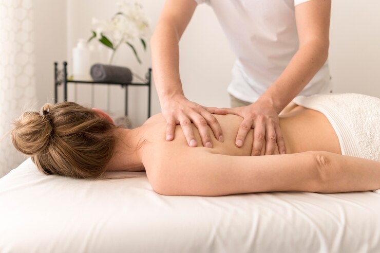 a masseur massaging a woman