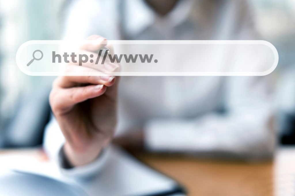 A hand pointing at a virtual search bar with the text "http://www."